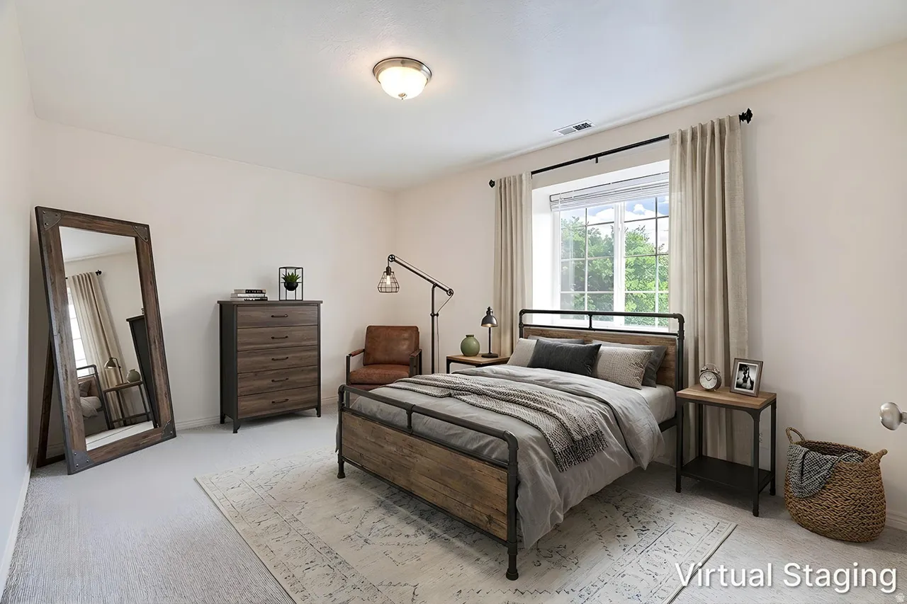 Light-filled room featuring a large window with white blinds, neutral wall paint, ceiling-mounted light fixture, and light-toned carpet flooring