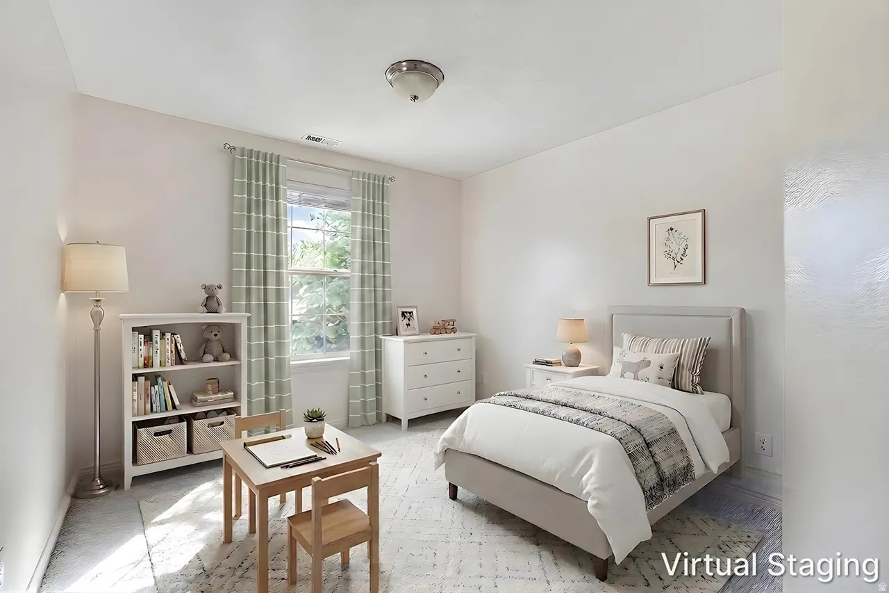 Bright interior room featuring a window with natural light, light-toned wall finishes, and ceiling-mounted lighting