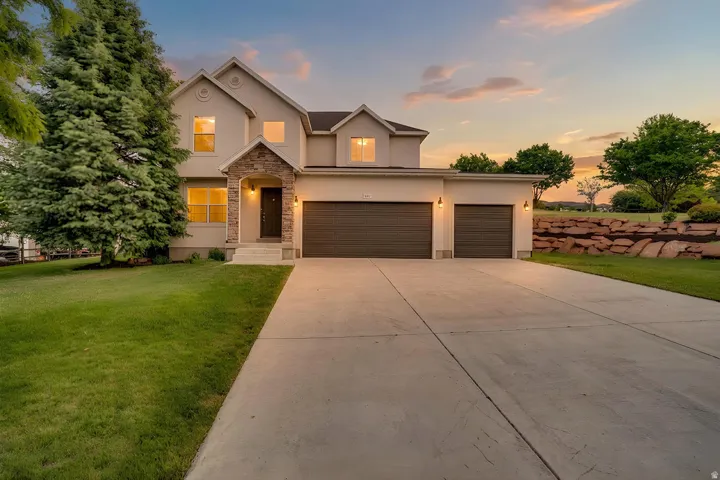 Stucco exterior with stone accents and a covered entry