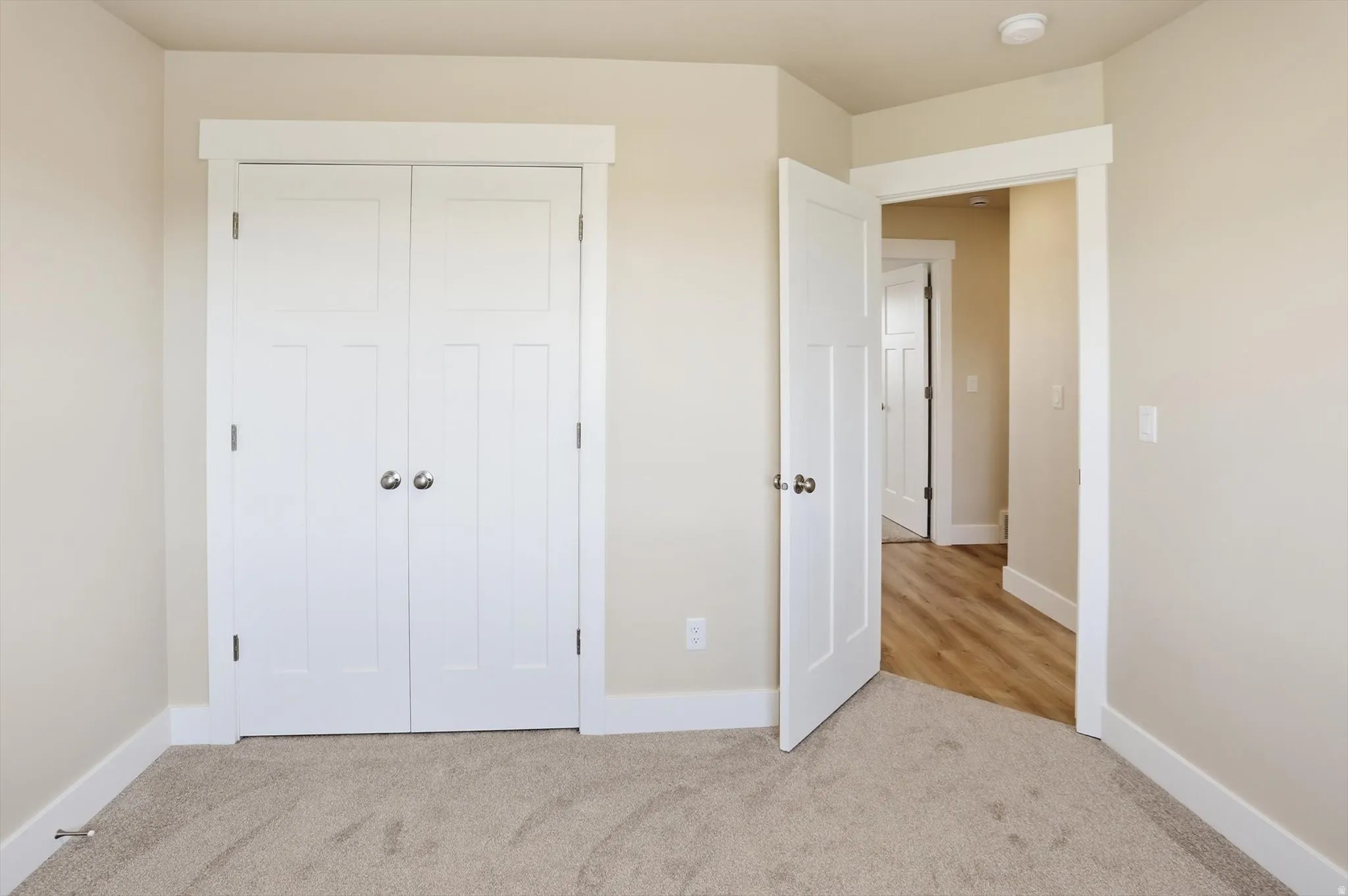 Warm neutral wall paint featuring white trim and solid doors