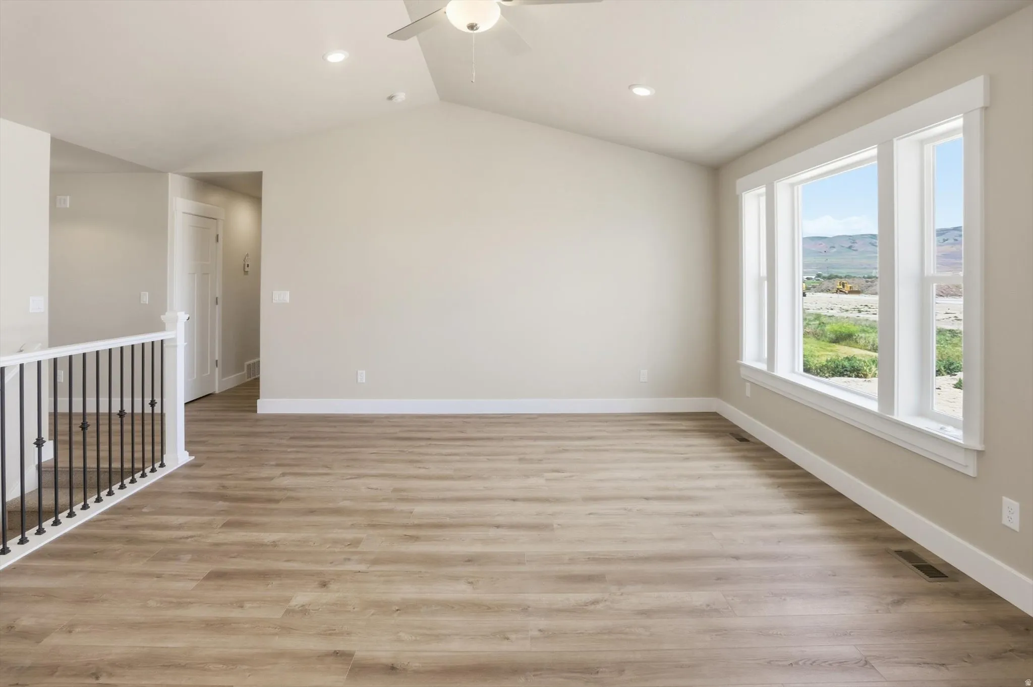 Spacious interior with vaulted ceilings and recessed lighting
