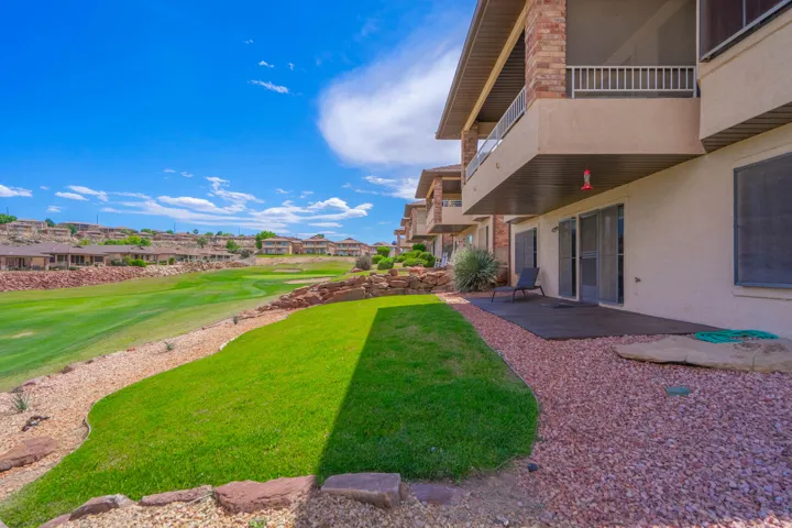 Ground-level patio opening onto a manicured lawn