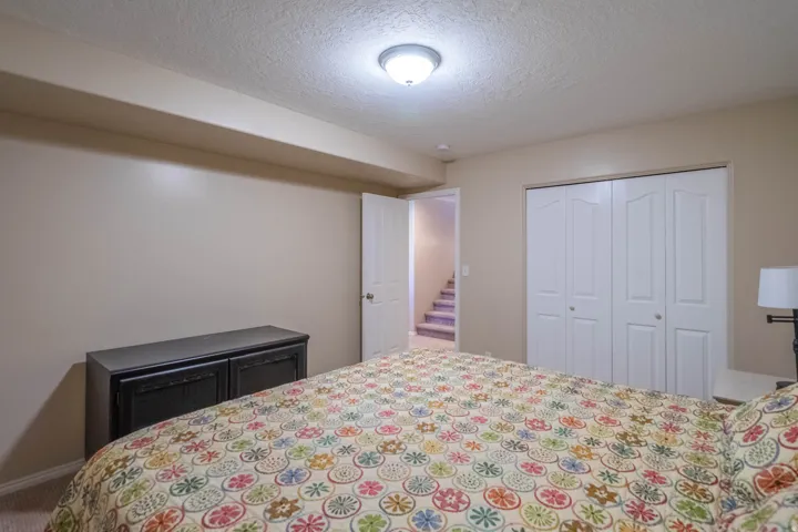 3rd Downstairs bedroom featuring neutral painted walls, textured ceiling, and recessed lighting