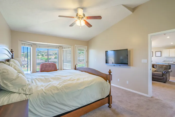 Primary bedroom featuring a vaulted ceiling and bay window