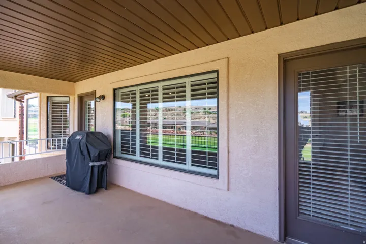 Covered outdoor patio featuring a textured stucco exterior
