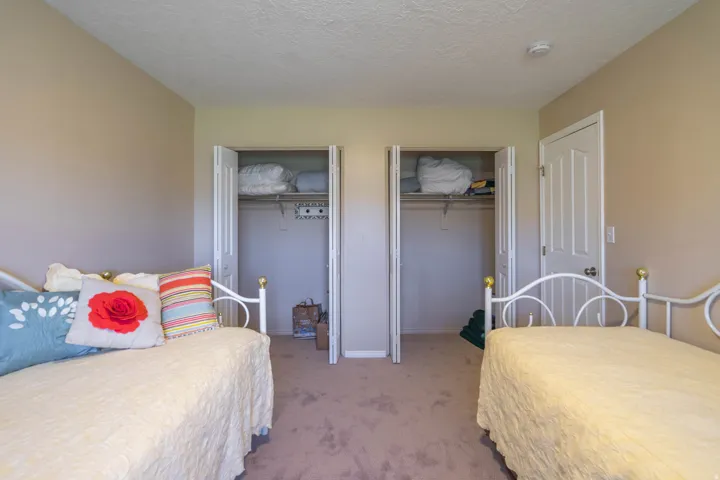 2nd Bedroom with eutral-toned walls complement the textured carpet flooring and double closets