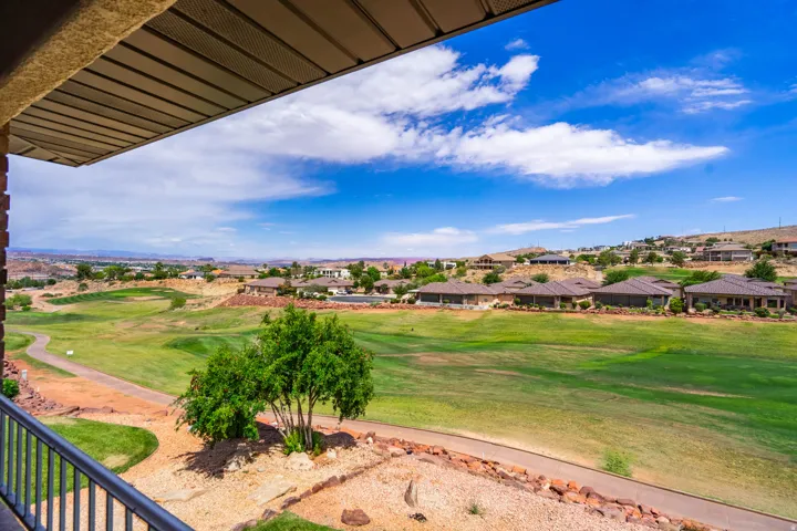View form patio of Expansive golf course frontage featuring manicured greens and a paved cart path