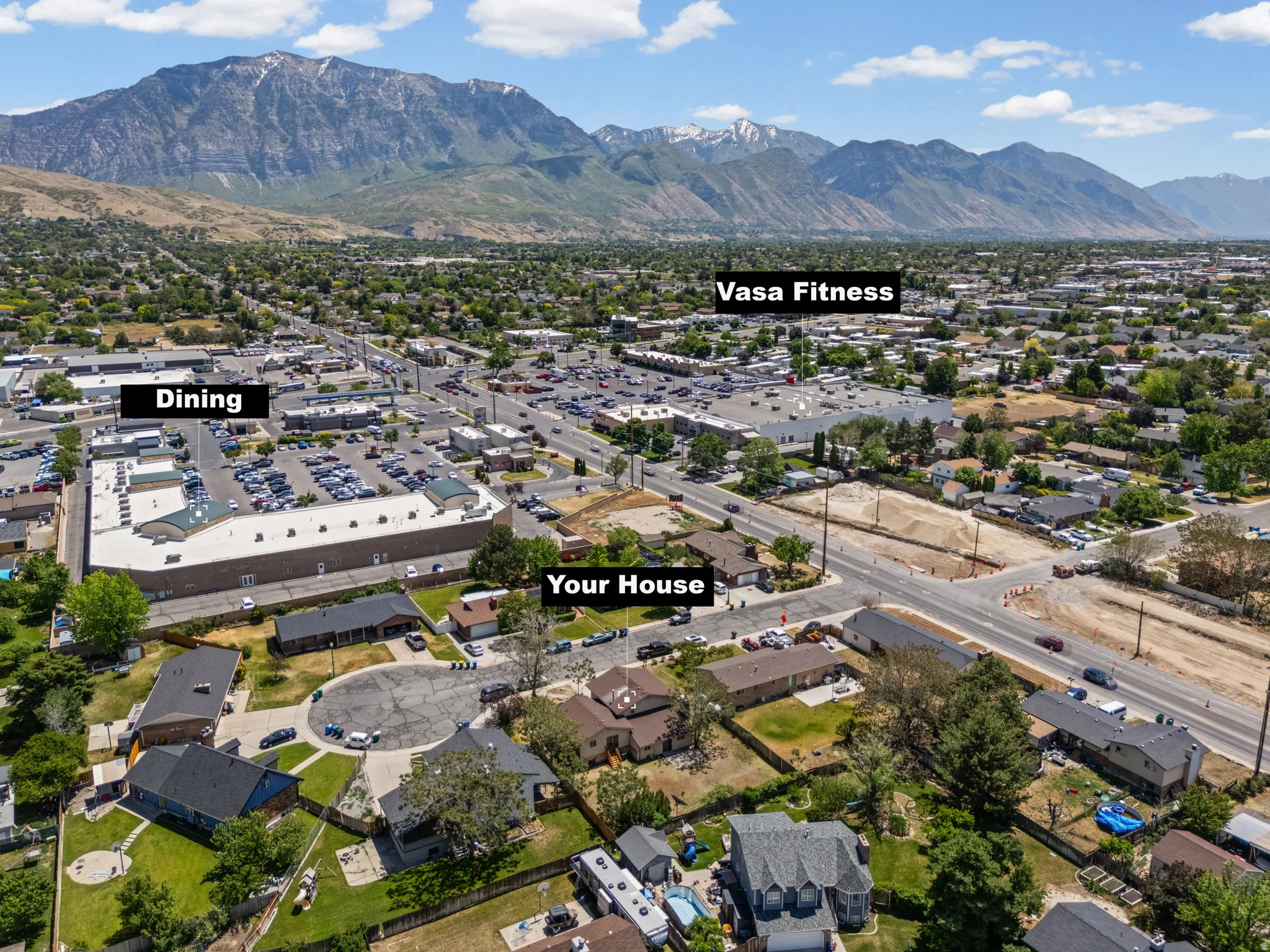 Aerial perspective of a developed neighborhood featuring residential properties and commercial establishments