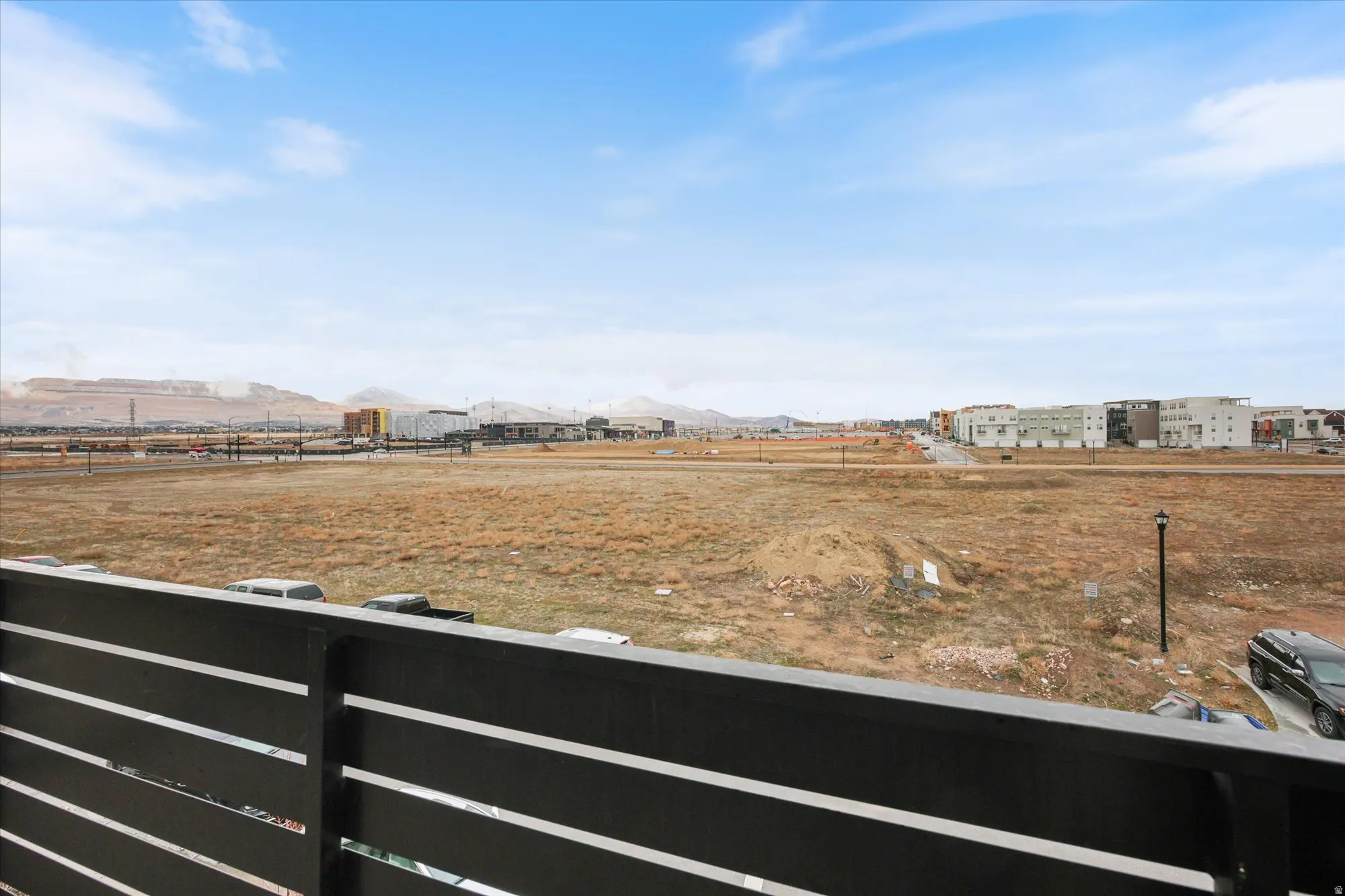 Expansive outdoor scenery featuring distant mountains and a developing community