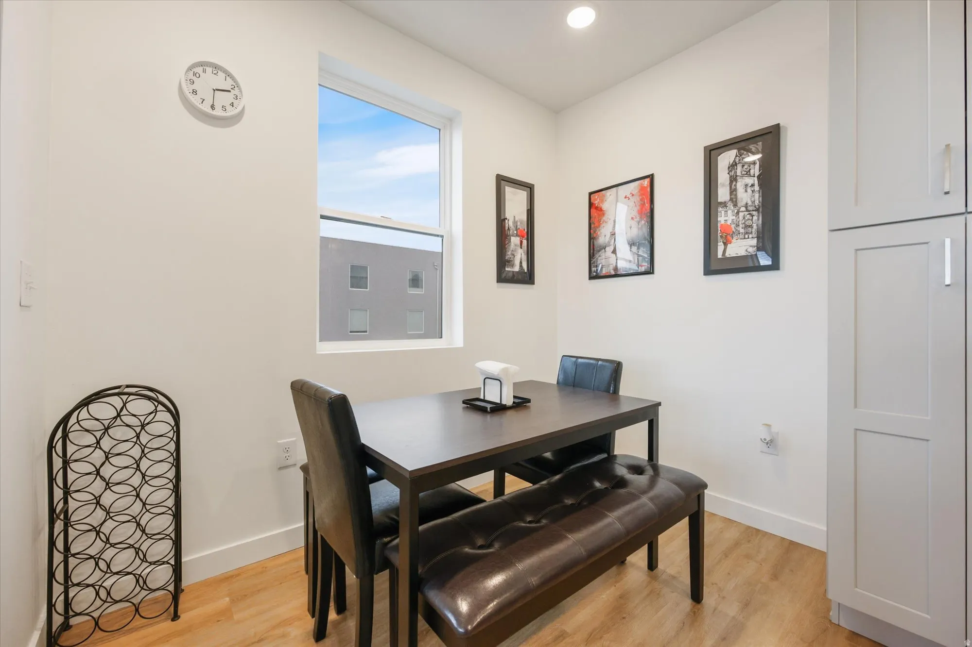 Compact dining area featuring wood-finish flooring and a single window