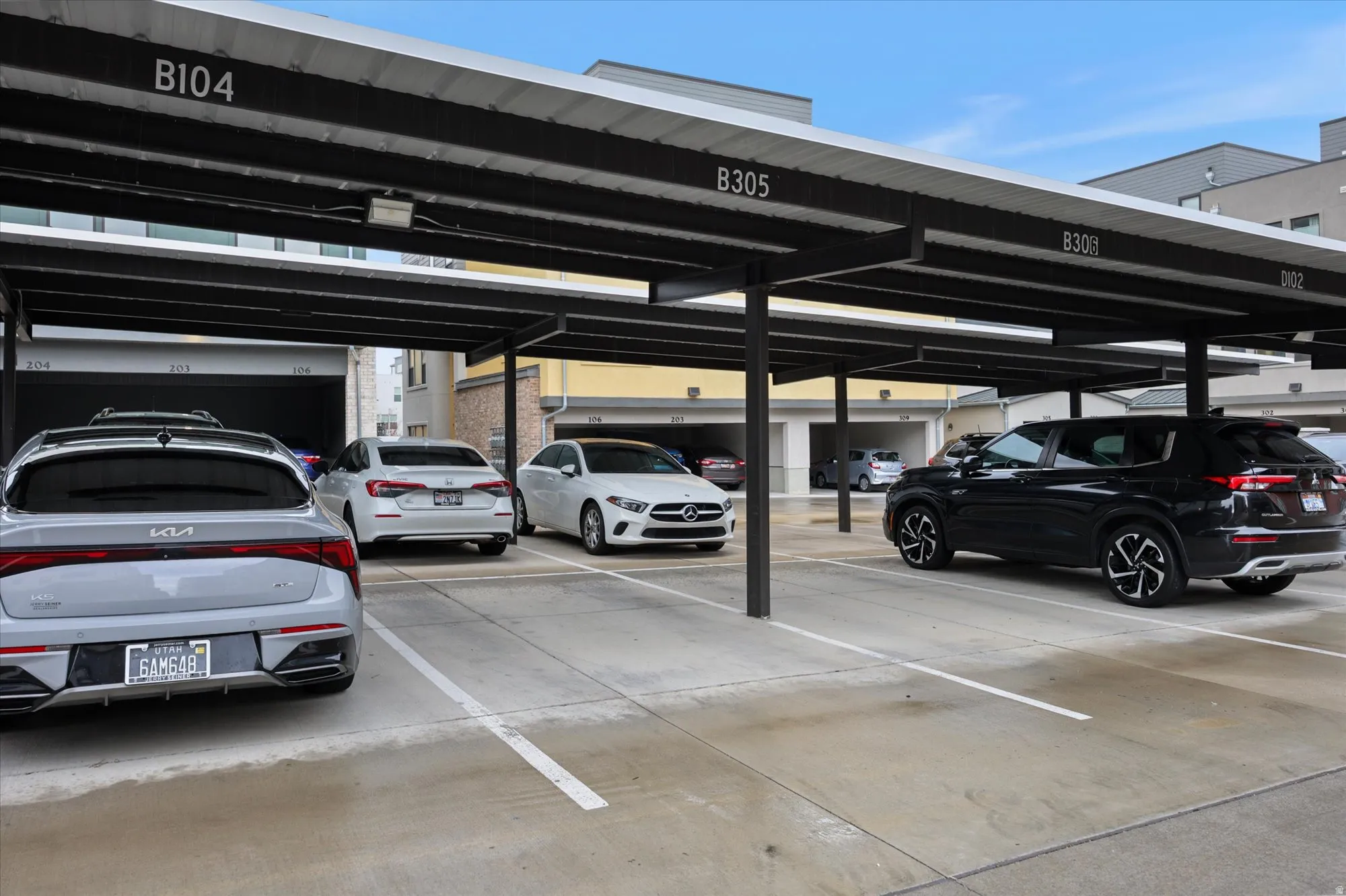 Covered parking structure featuring numbered spaces and overhead lighting