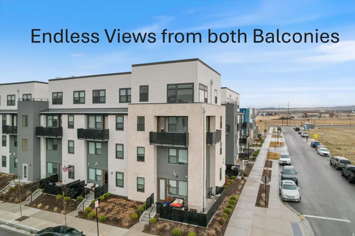 Multi-story townhome exterior featuring modern architectural design with mixed material facades