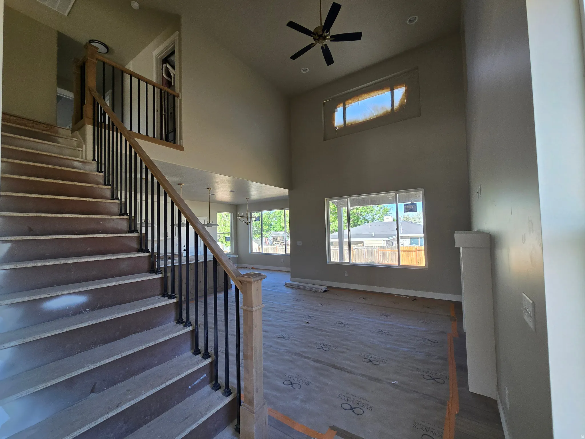 Grand entryway featuring a staircase with black metal balusters and wood-finish handrails