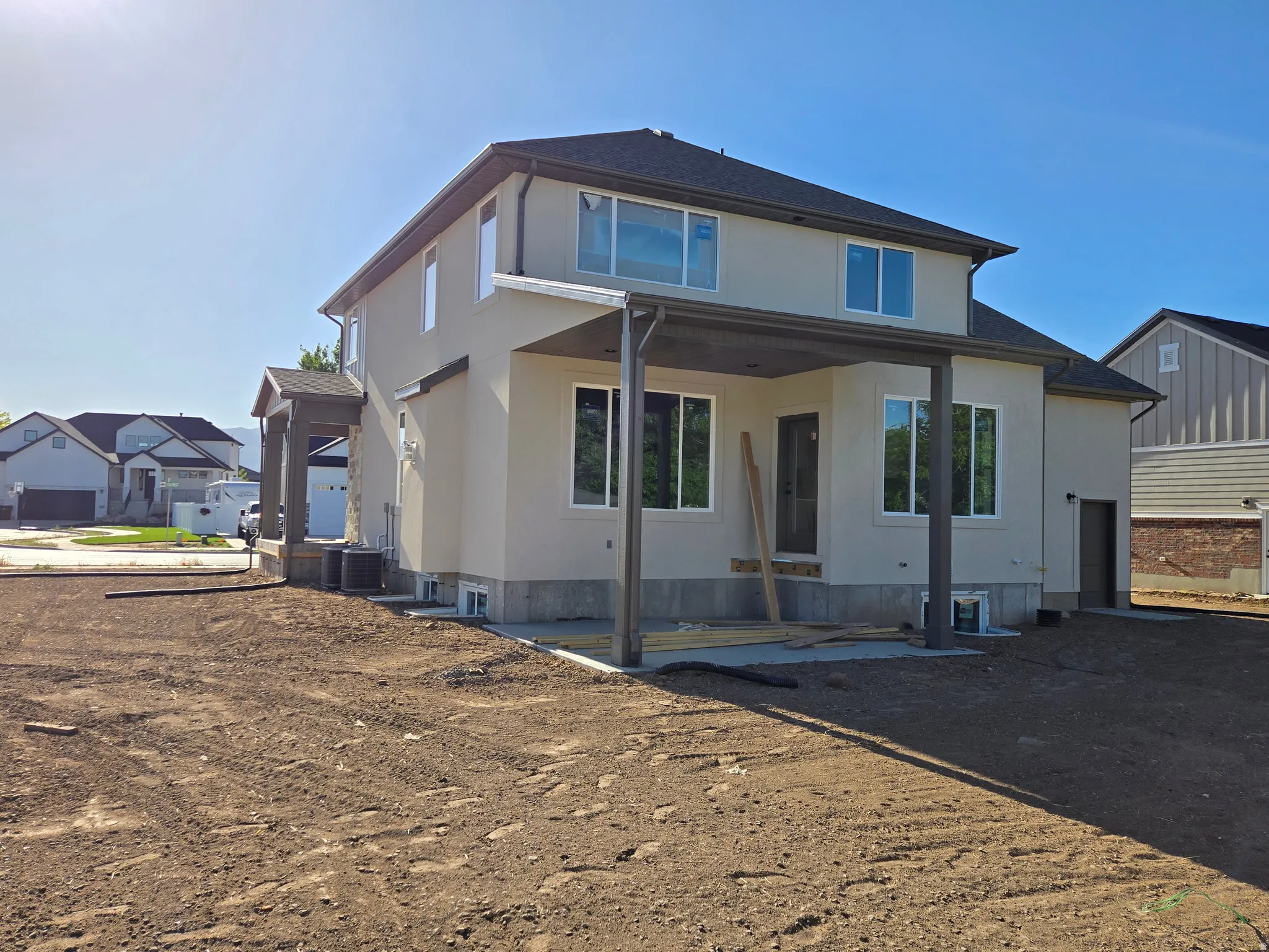 Contemporary two-story residence with a stucco exterior and dark-framed windows