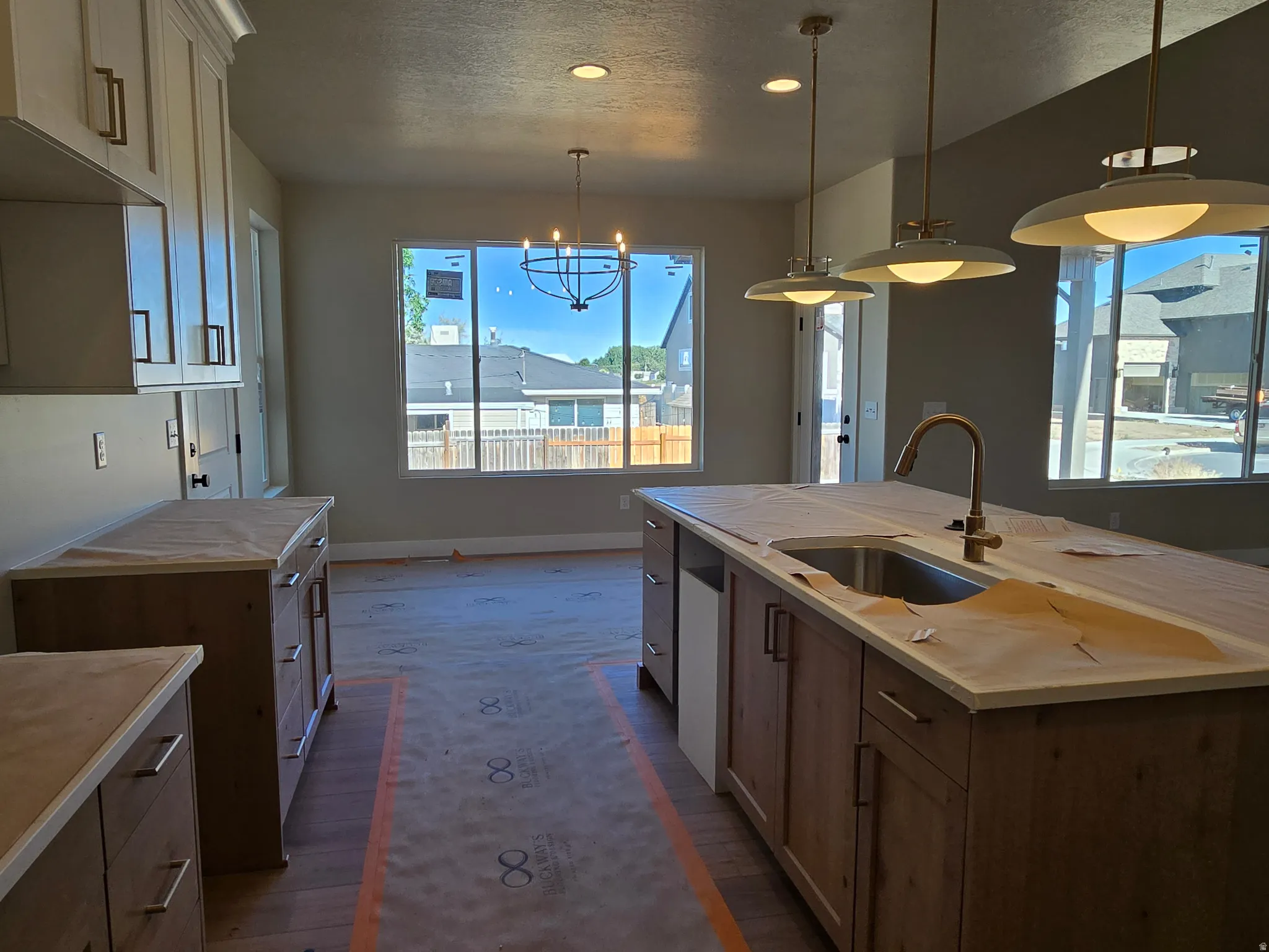 Spacious kitchen featuring a large central island with an undermount sink and gooseneck faucet