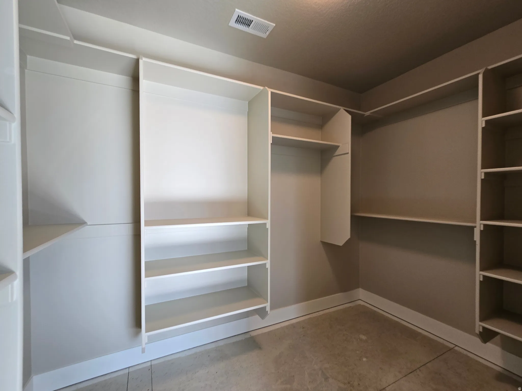 Built-in closet system featuring multiple shelving units and hanging rods