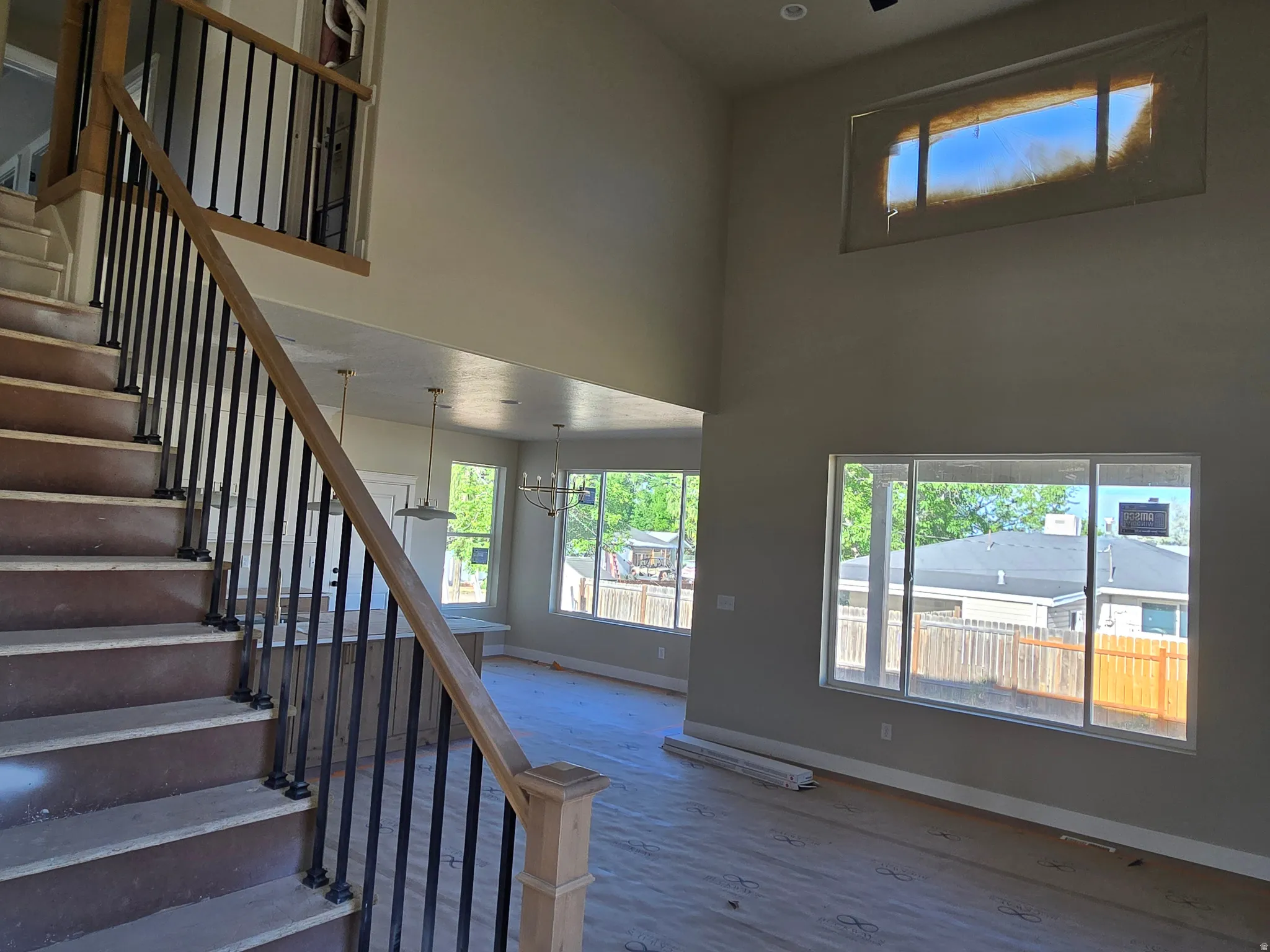 Grand staircase featuring wood-finish handrails and black metal balusters
