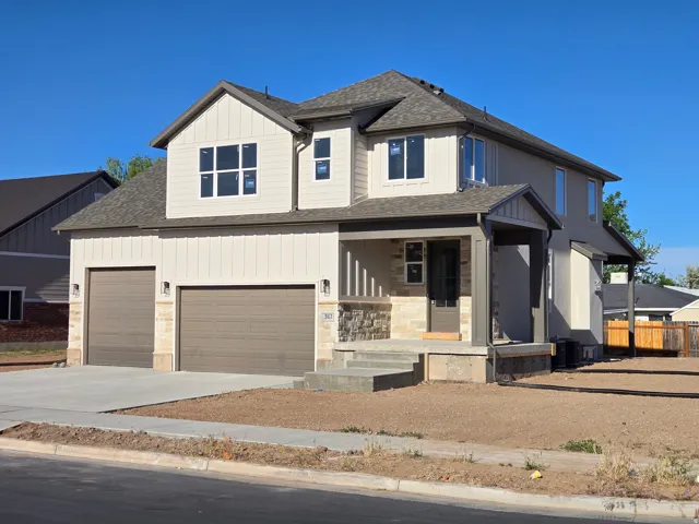 Two-story exterior featuring a stone and board and batten facade