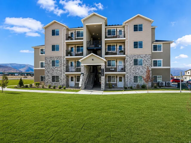 Multi-story building featuring a facade of horizontal siding and stone accents