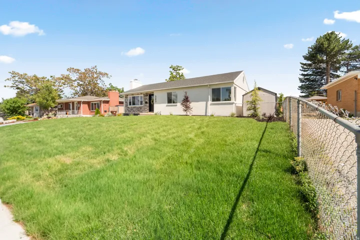 Expansive front lawn with a gentle slope