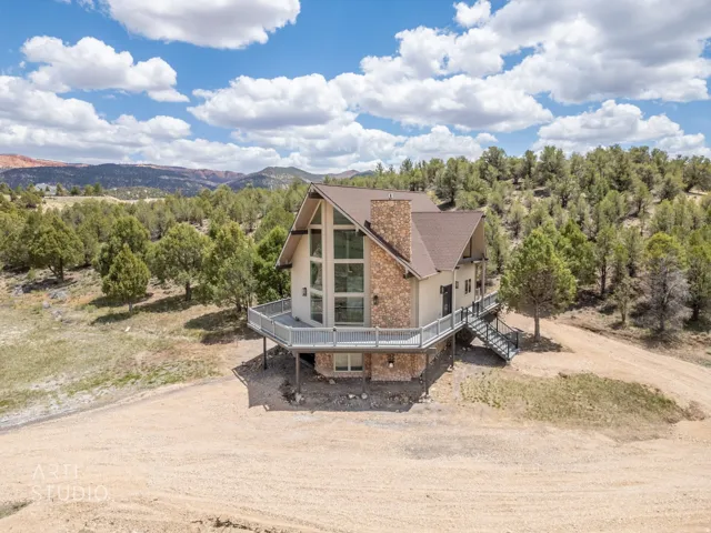 A-frame architectural style with a stone and stucco exterior