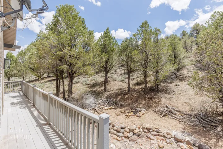 Expansive outdoor deck with composite decking and light-toned railings, providing a direct connection to the surrounding natural landscape