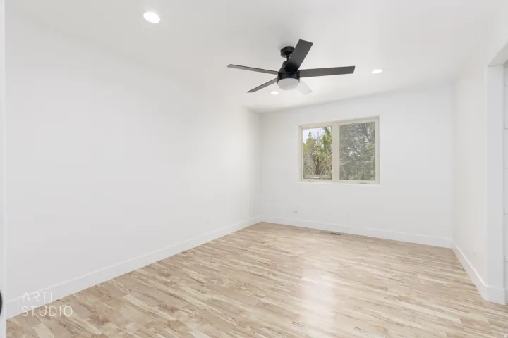 Room featuring wood-finish flooring, recessed lighting, and a modern ceiling fan