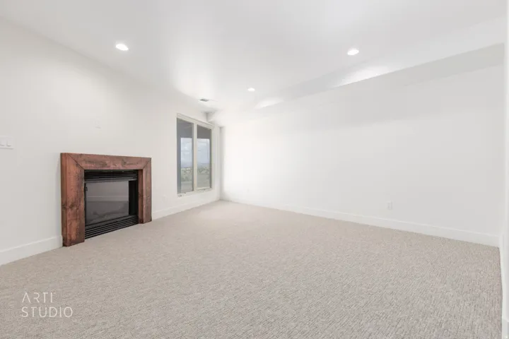 Recessed fireplace with a rustic wood surround