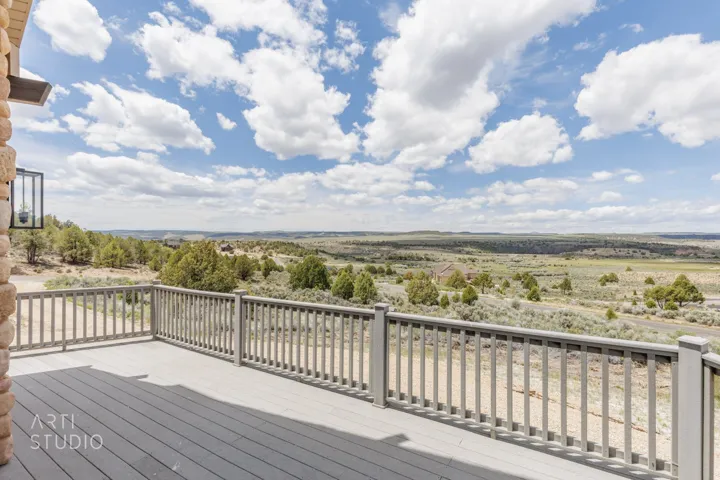 Expansive outdoor deck featuring grey composite decking and matching railings