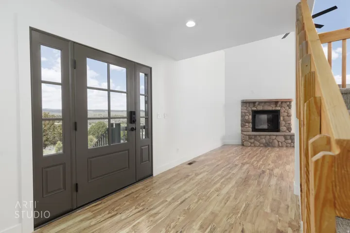 Entryway featuring a double door with glass lites and a transom window