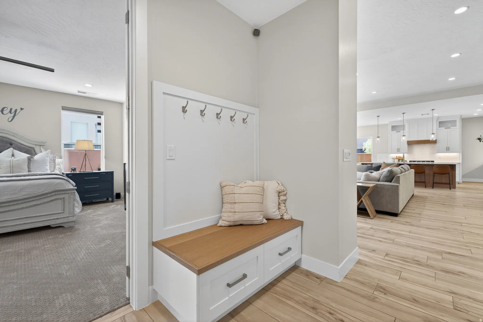 Entryway with built-in bench seating, wood-finish top, and storage drawers