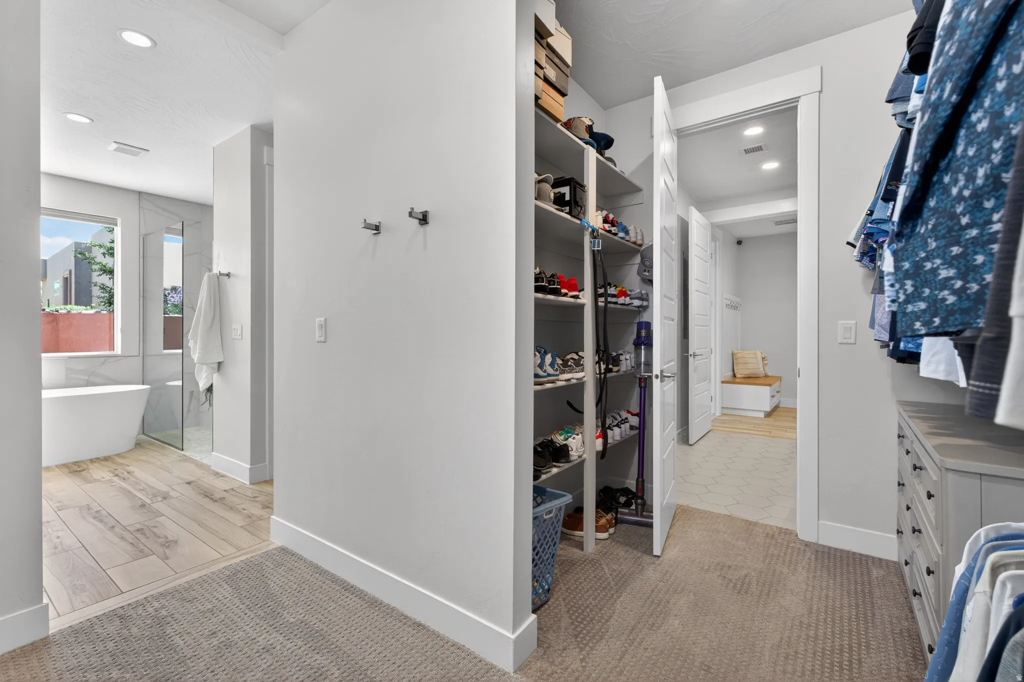 Walk-in closet with built-in shelving and dresser cabinetry