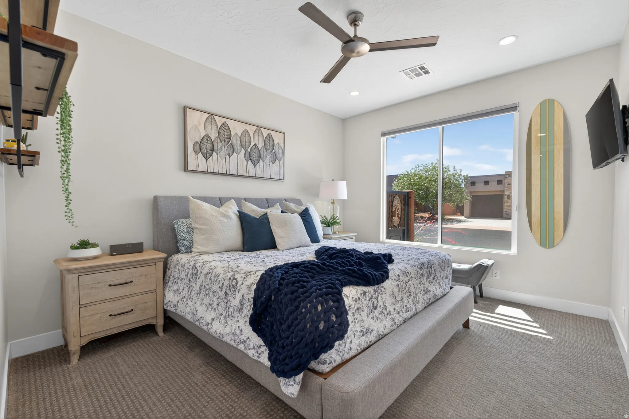 Spacious bedroom featuring neutral wall tones, carpeted flooring, a ceiling fan with integrated lighting, recessed lighting, and a large window