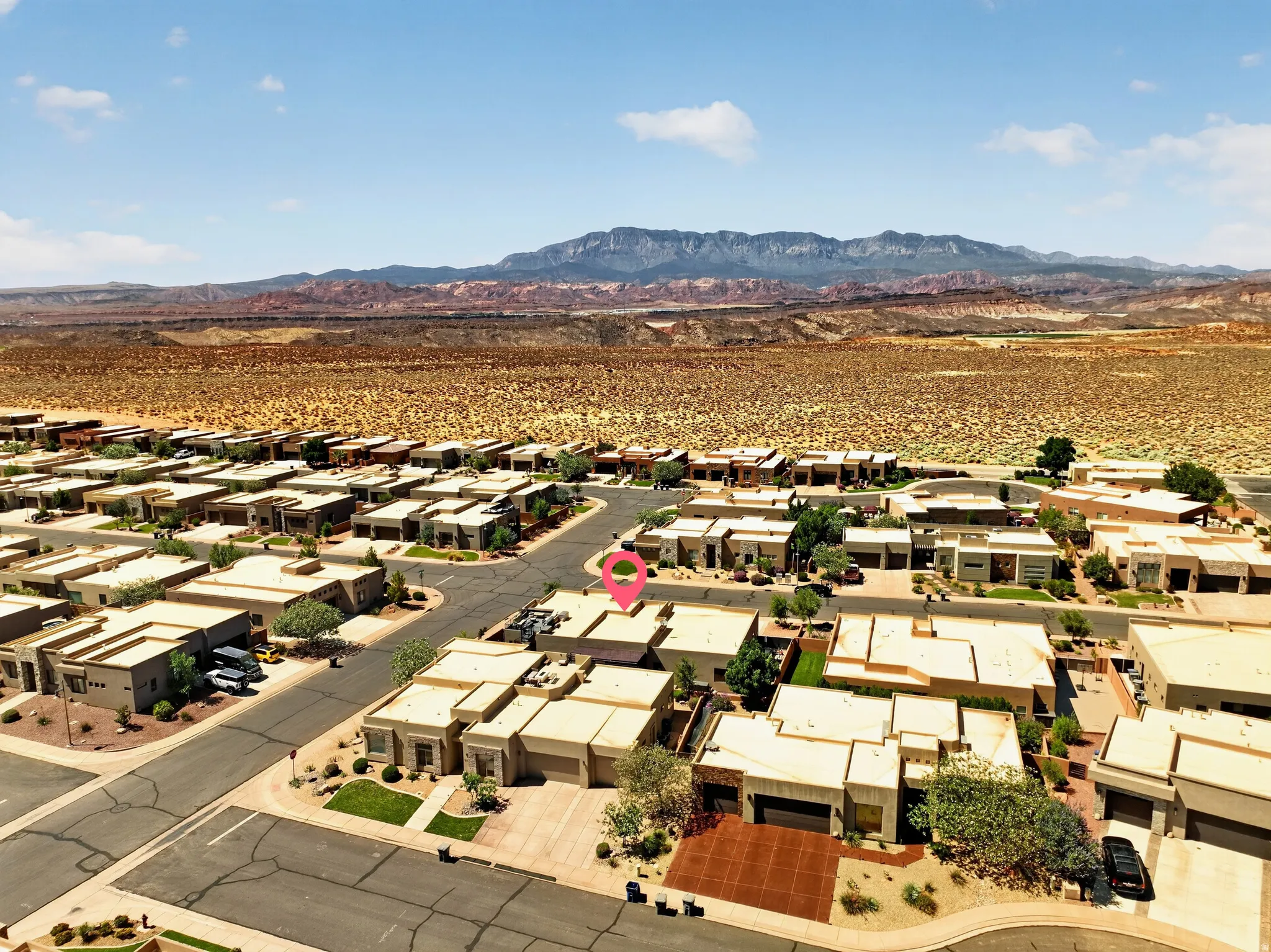 Residential neighborhood with a desert landscape backdrop and distant mountains