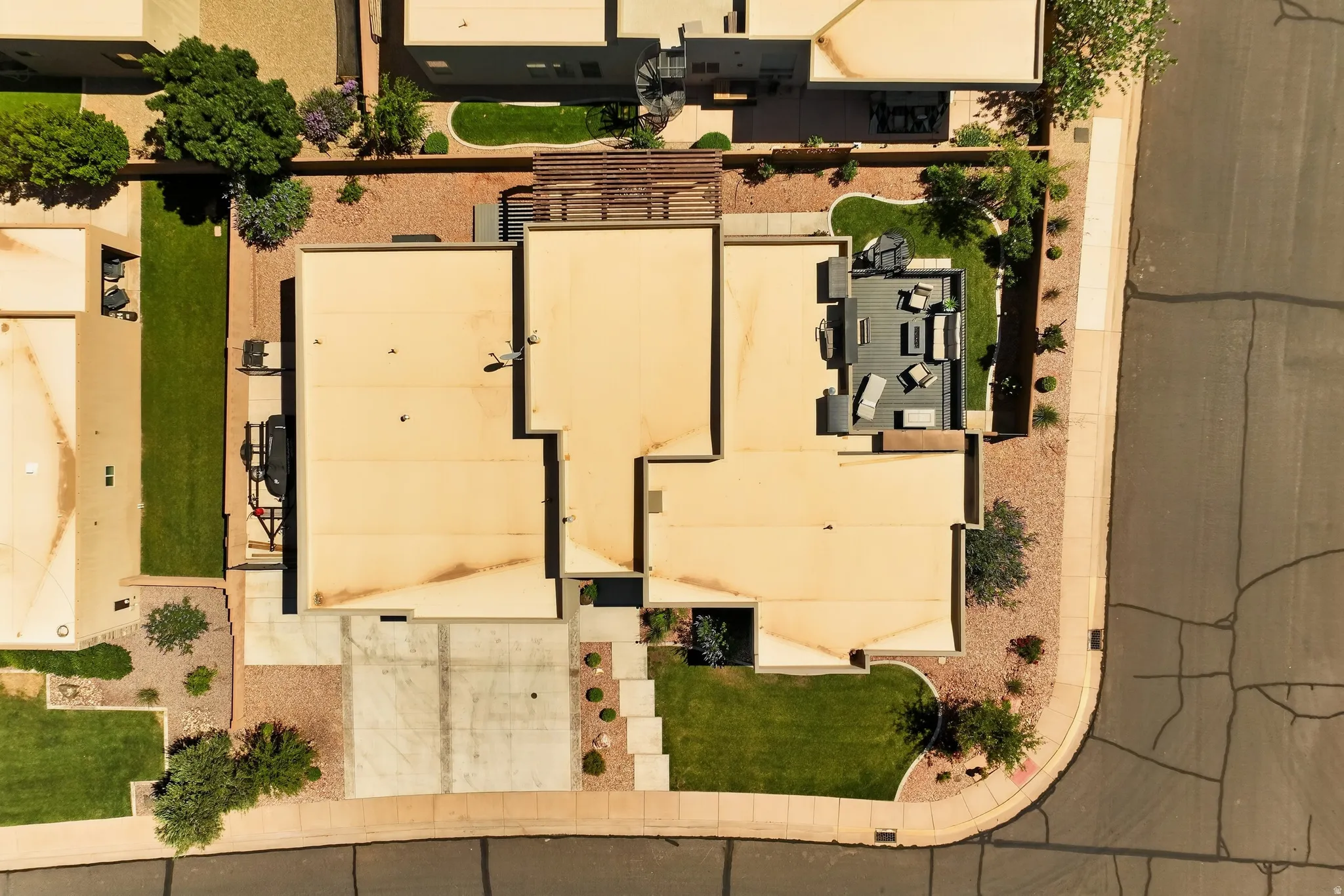 Property featuring a private courtyard patio, a gravel yard, and a concrete driveway
