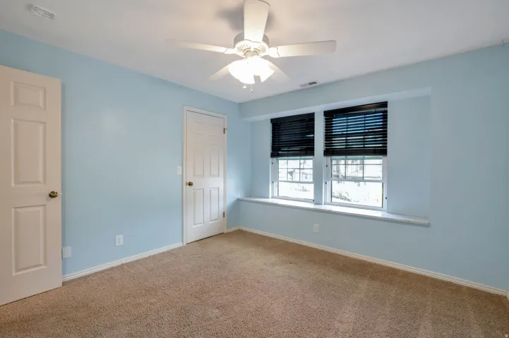 Carpeted room with light blue walls and white trim