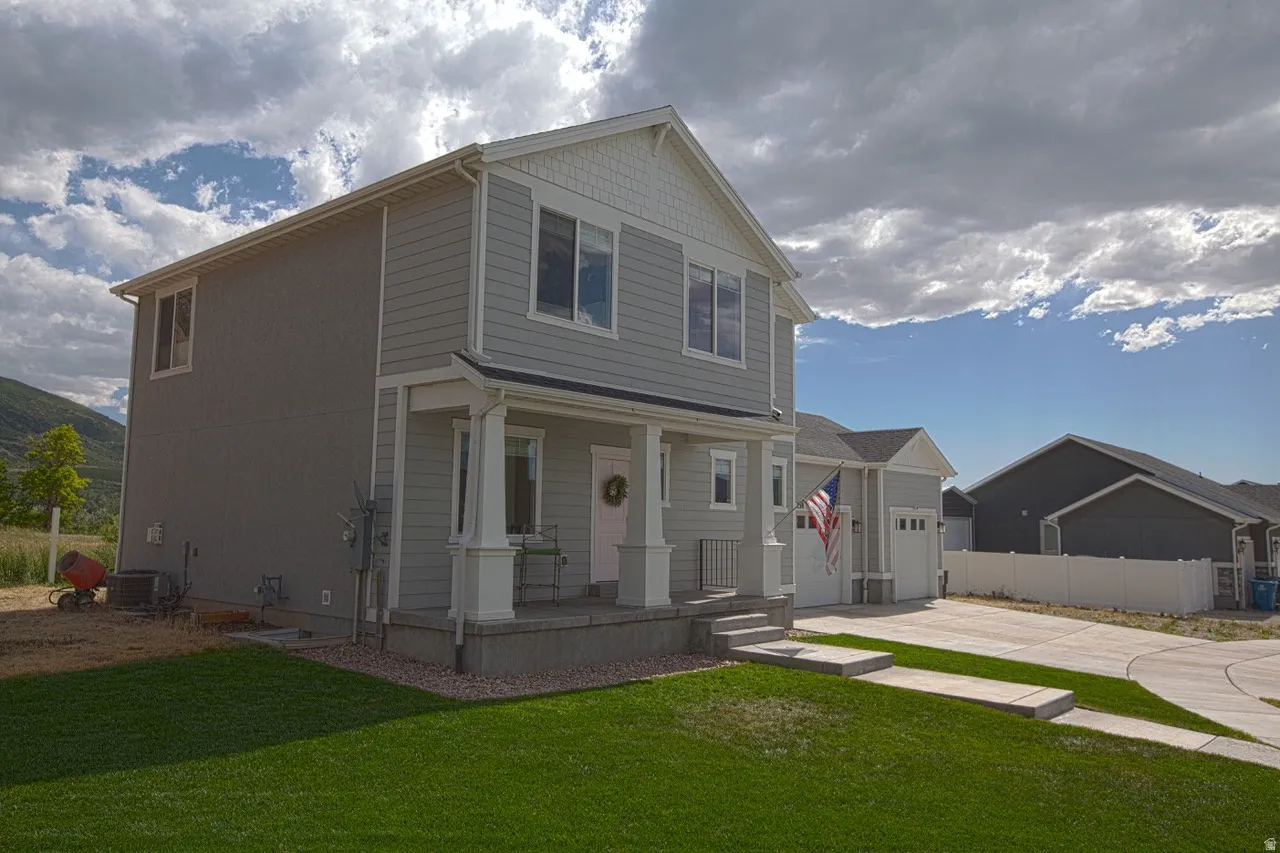 Contemporary two-story residence featuring light gray siding and white trim