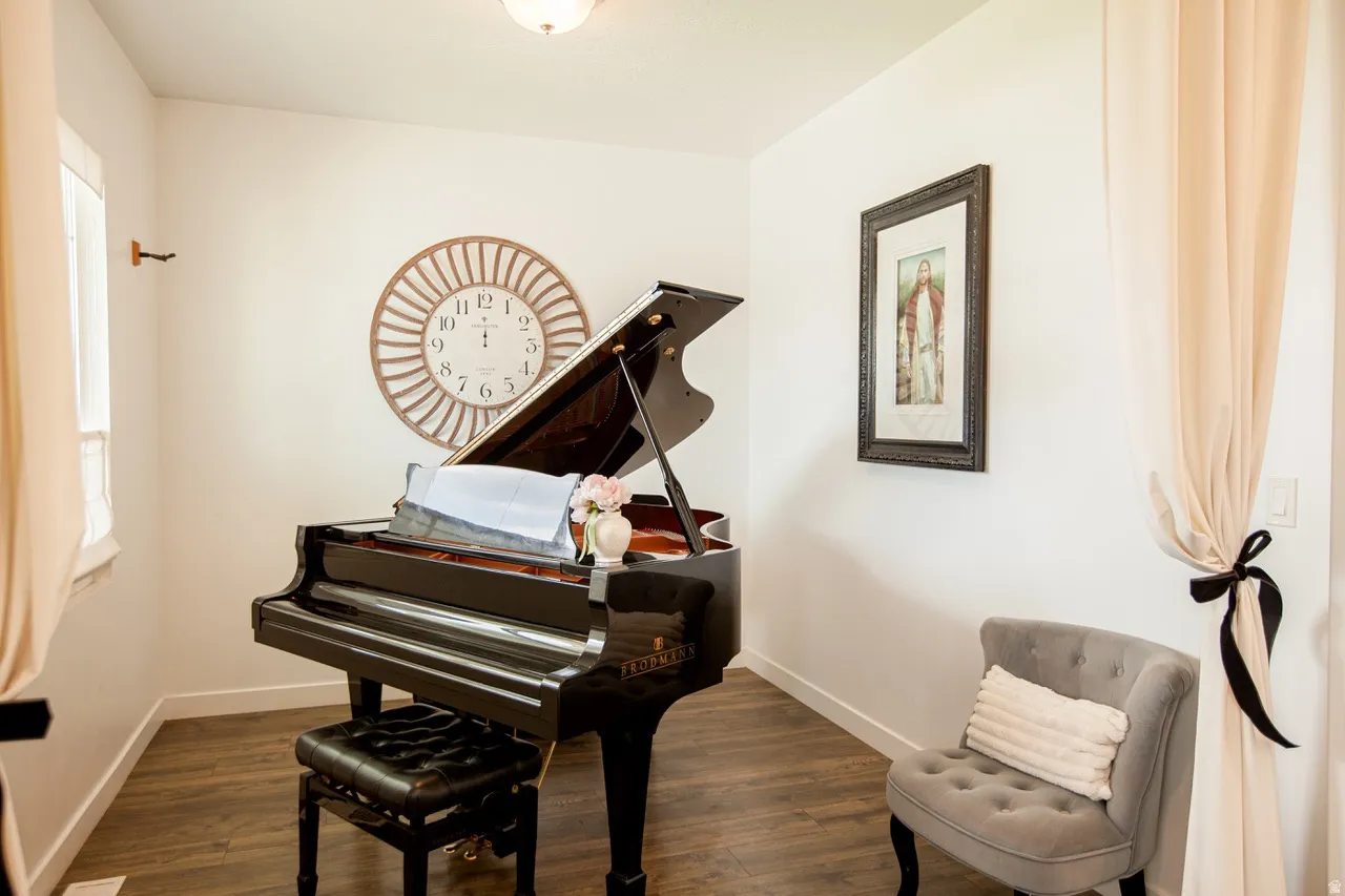Interior room featuring wood-finish flooring, white walls, and a ceiling-mounted light fixture