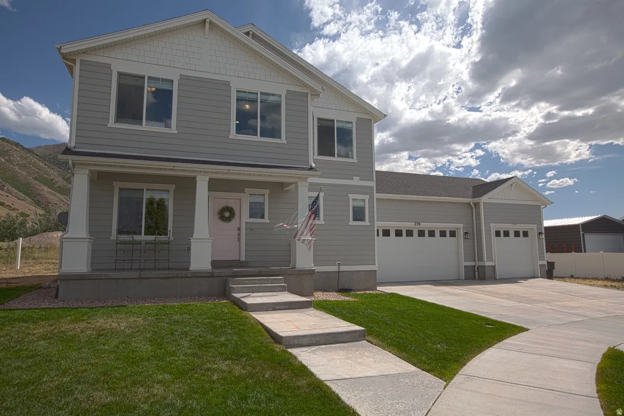 Modern two-story residence featuring light gray siding and white trim