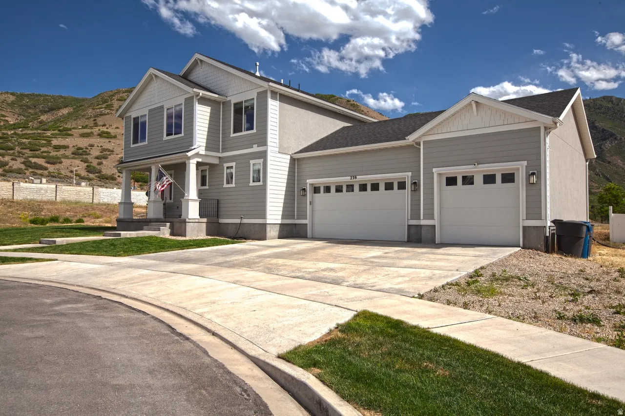 Modern two-story residence featuring light gray siding and white trim