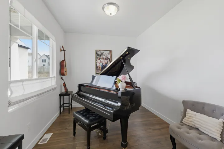 Wood-finish flooring, white walls, and a contemporary ceiling light fixture