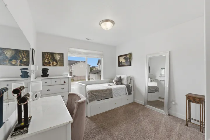 White walls, light-colored carpet flooring, recessed window, and flush mount ceiling light fixture