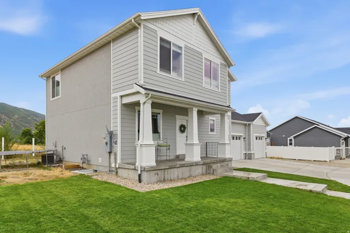 Two-story residence featuring a gray siding and stucco exterior