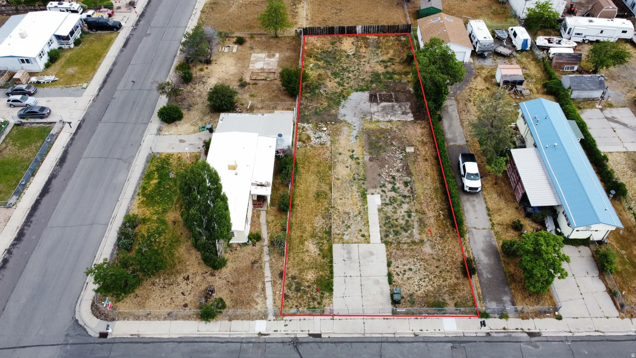 Expansive undeveloped lot featuring street frontage and a concrete driveway
