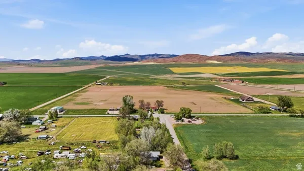 Expansive agricultural landscape featuring diverse crop fields and distant foothills