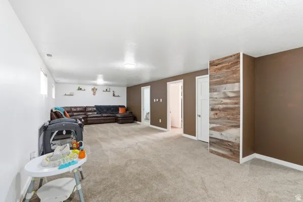 Spacious lower-level room featuring carpeted flooring and recessed lighting