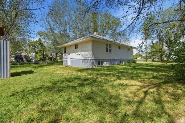 Spacious backyard with mature trees providing ample shade