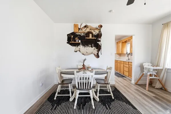 Light wood-finish flooring extends through the space