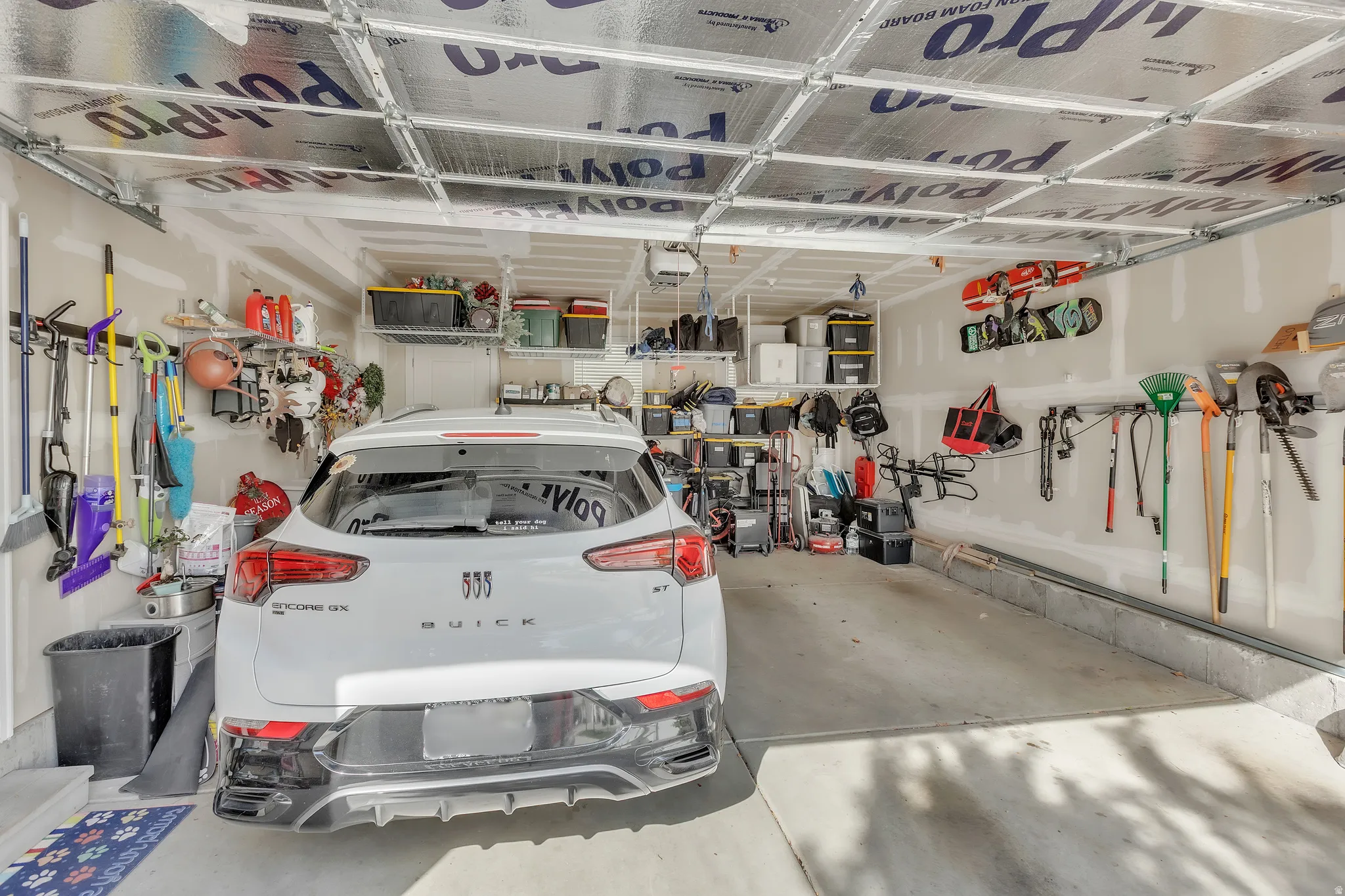 Attached garage featuring a concrete floor and insulated ceiling