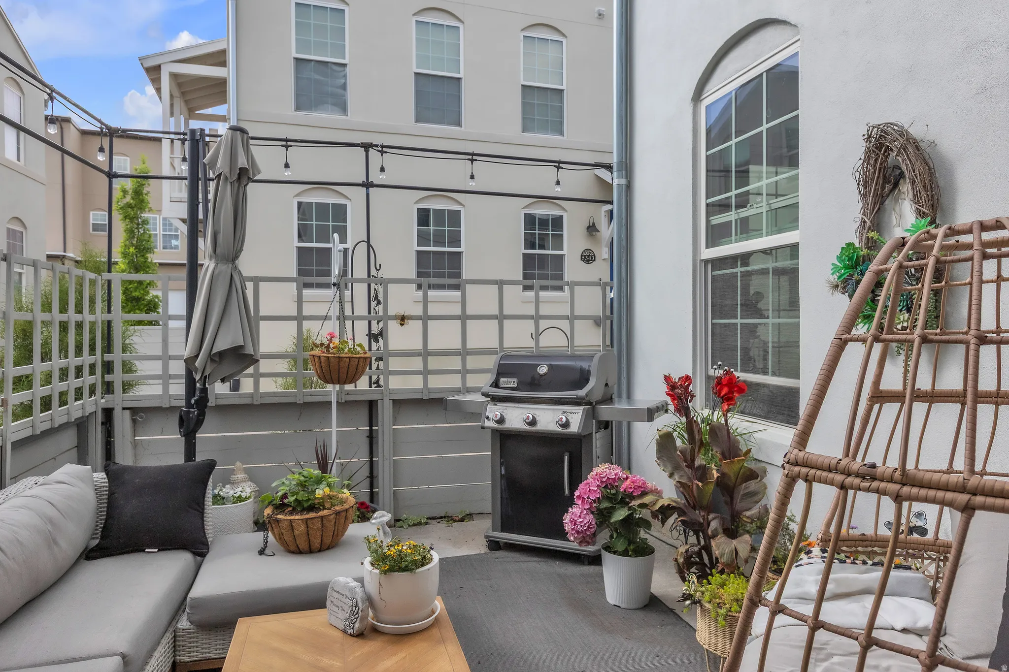Private outdoor patio featuring a gray privacy fence with lattice detail